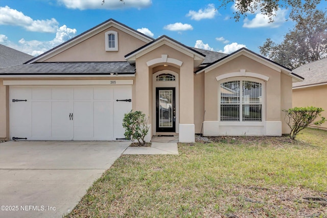 view of front of property with a garage, concrete driveway, a front lawn, and stucco siding