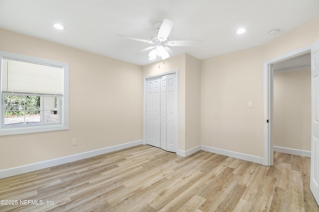 unfurnished bedroom with light wood-style floors, a closet, recessed lighting, and baseboards