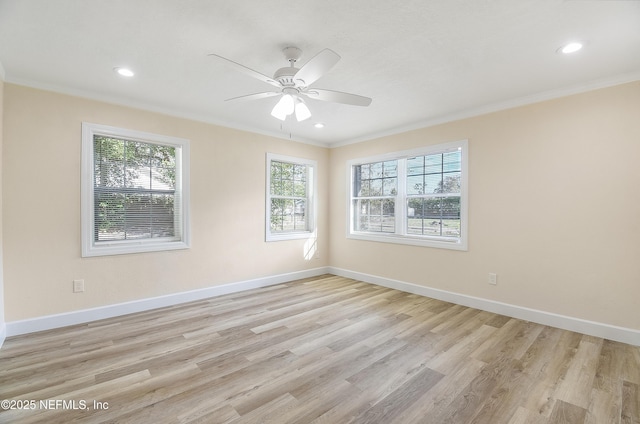 empty room featuring light wood-style floors, baseboards, and ornamental molding