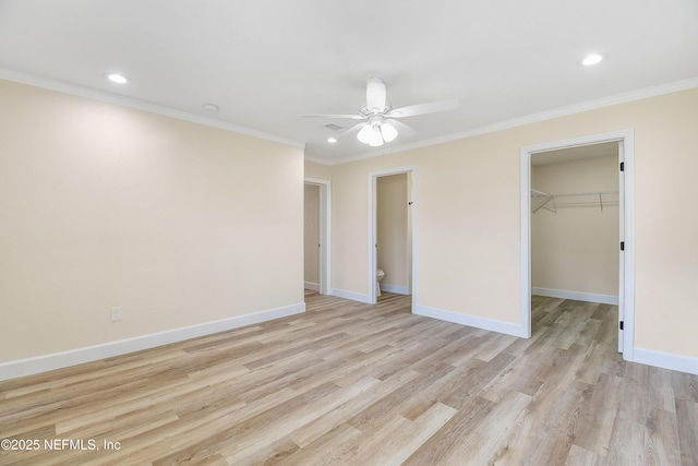 unfurnished bedroom with crown molding, light wood finished floors, and baseboards