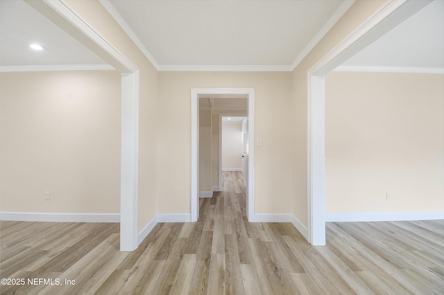 hallway with ornamental molding, light wood-type flooring, and baseboards