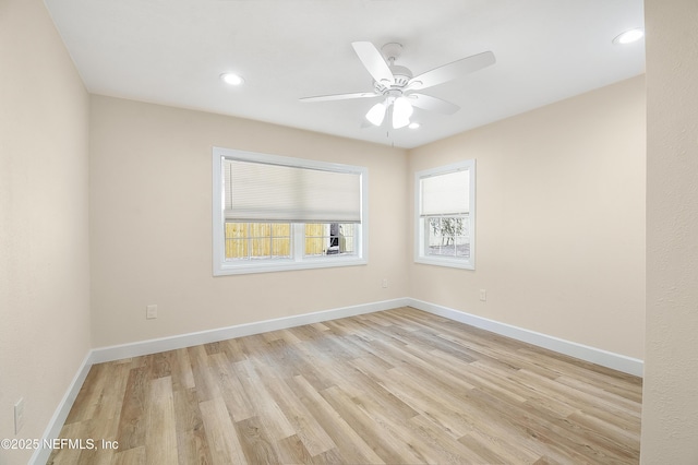 spare room featuring a ceiling fan, recessed lighting, light wood finished floors, and baseboards