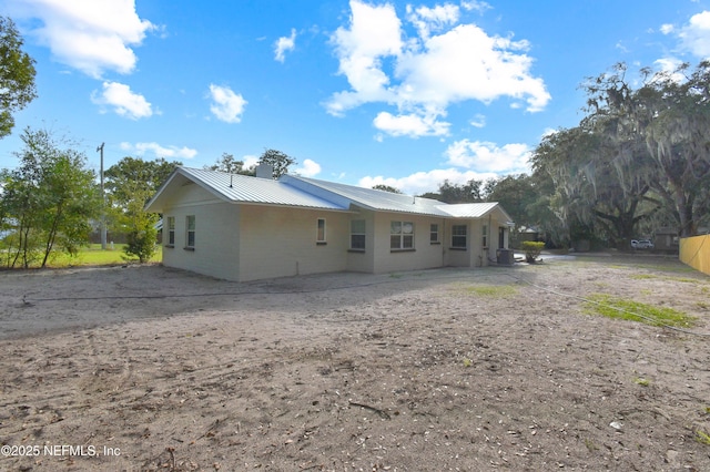 rear view of property featuring metal roof