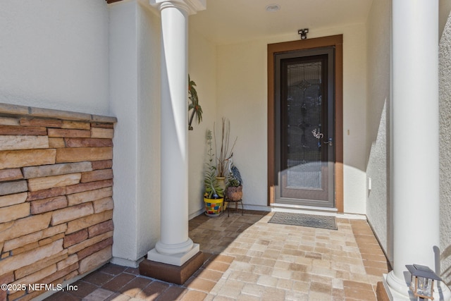 view of exterior entry featuring stucco siding