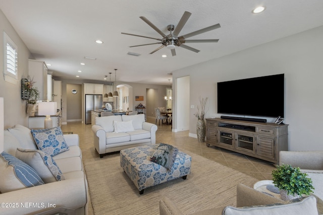 living room featuring light tile patterned floors, recessed lighting, a ceiling fan, baseboards, and visible vents