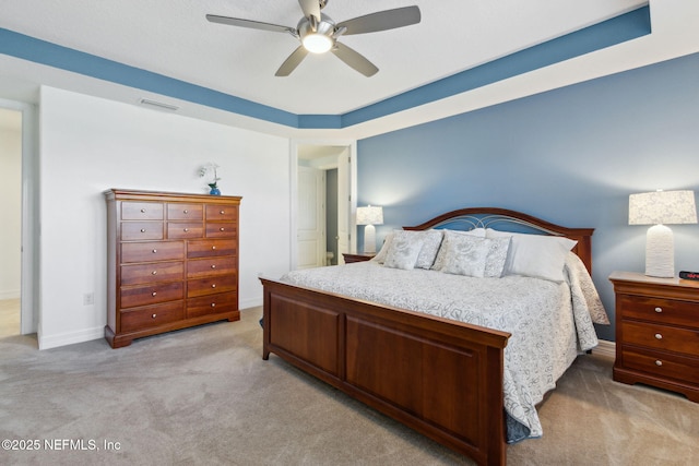 bedroom with light carpet, baseboards, visible vents, and a ceiling fan