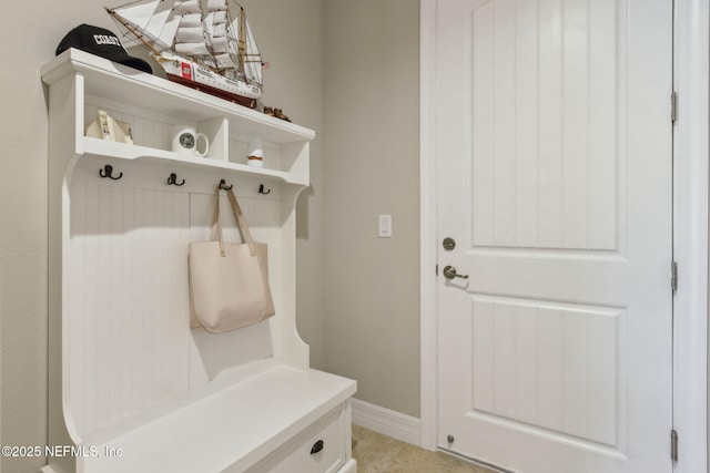 mudroom with baseboards and light tile patterned flooring