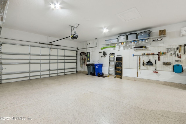 garage with a garage door opener and electric panel