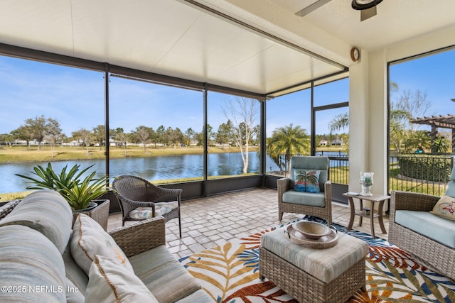 sunroom with a water view and a ceiling fan