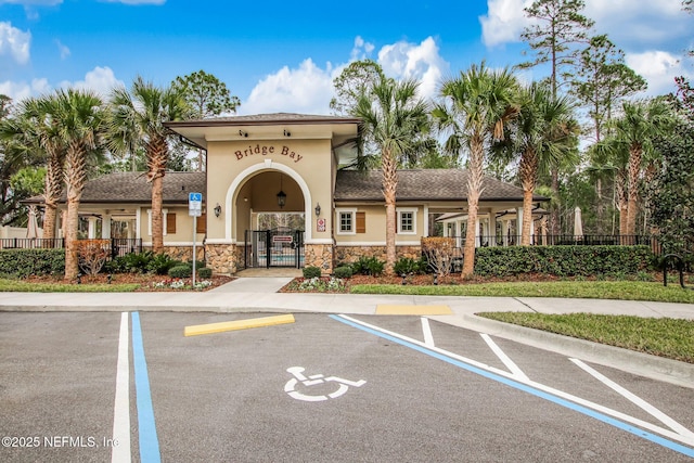 view of property featuring uncovered parking and fence