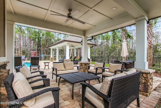 view of patio with ceiling fan, an outdoor hangout area, and fence