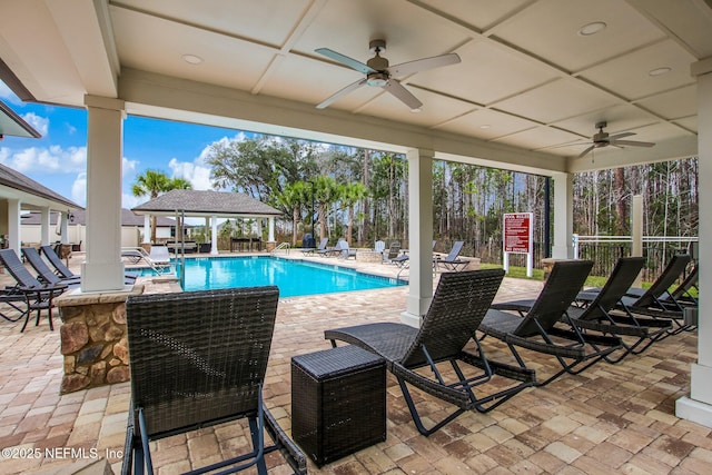 community pool featuring ceiling fan, fence, and a patio