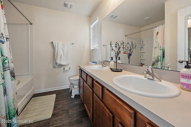 full bath with toilet, wood finished floors, a sink, and visible vents