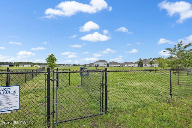 view of yard with fence and a gate