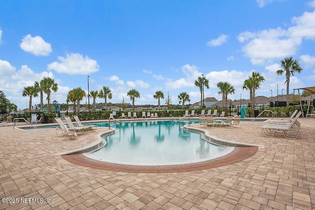 pool featuring a patio area and fence