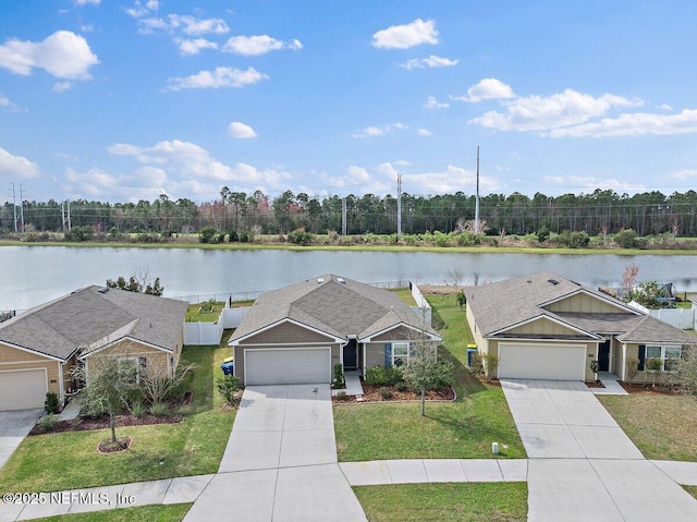 exterior space with a front yard, concrete driveway, a water view, and an attached garage