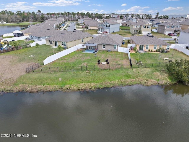 birds eye view of property with a water view and a residential view