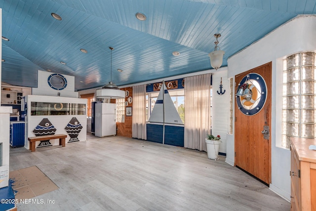 garage with wooden ceiling and freestanding refrigerator