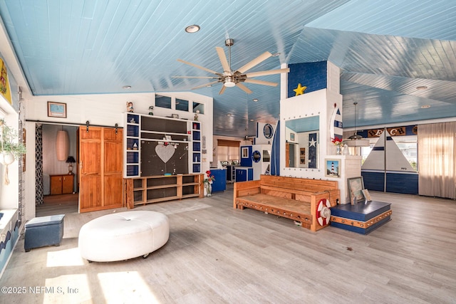 interior space featuring wood ceiling, lofted ceiling, wood finished floors, and a barn door