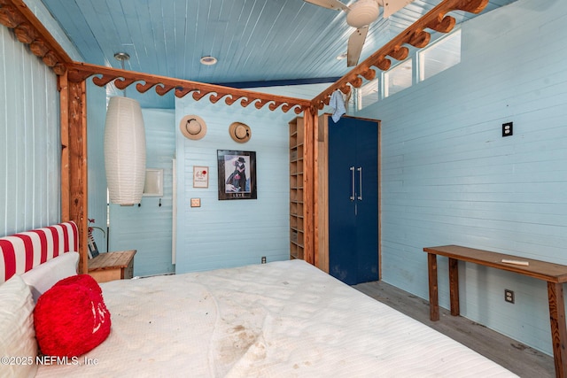 bedroom featuring wooden ceiling and wooden walls