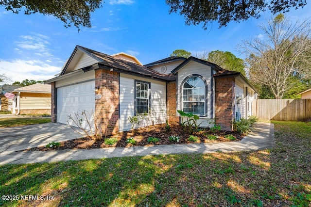 view of front of property featuring a garage, concrete driveway, brick siding, and fence