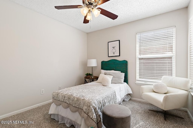 carpeted bedroom with ceiling fan, baseboards, and a textured ceiling