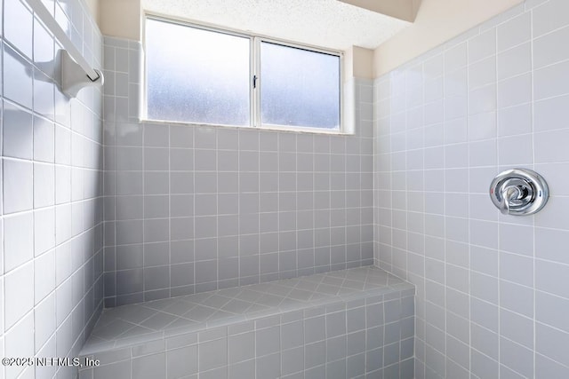 full bath with a tile shower