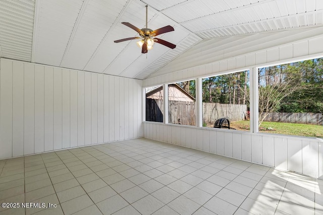 unfurnished sunroom featuring a ceiling fan and vaulted ceiling