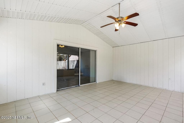 spare room featuring lofted ceiling and a ceiling fan