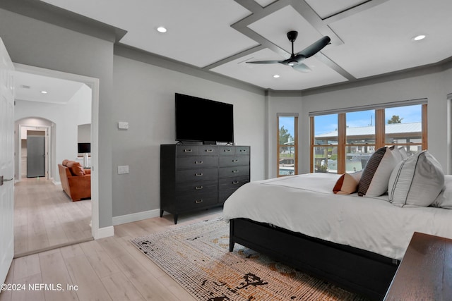 bedroom with baseboards, arched walkways, a ceiling fan, light wood-style flooring, and recessed lighting