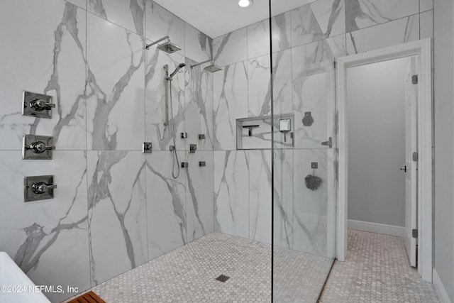 bathroom featuring a marble finish shower