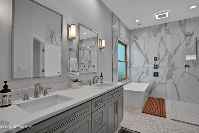 full bath with double vanity, a freestanding tub, a sink, and a marble finish shower