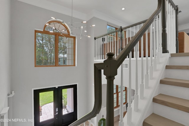 staircase with french doors, recessed lighting, visible vents, ornamental molding, and a chandelier