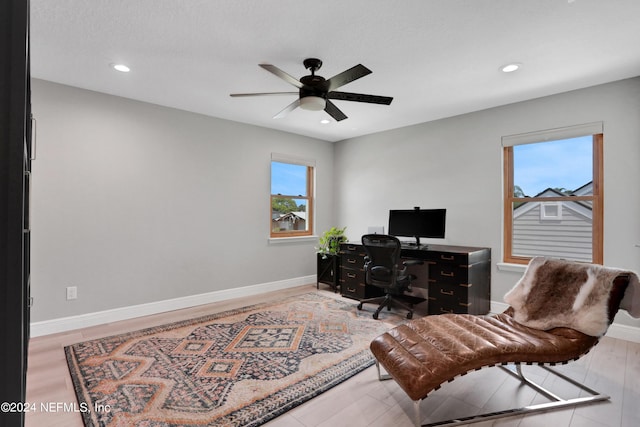 office space featuring recessed lighting, a healthy amount of sunlight, ceiling fan, and baseboards