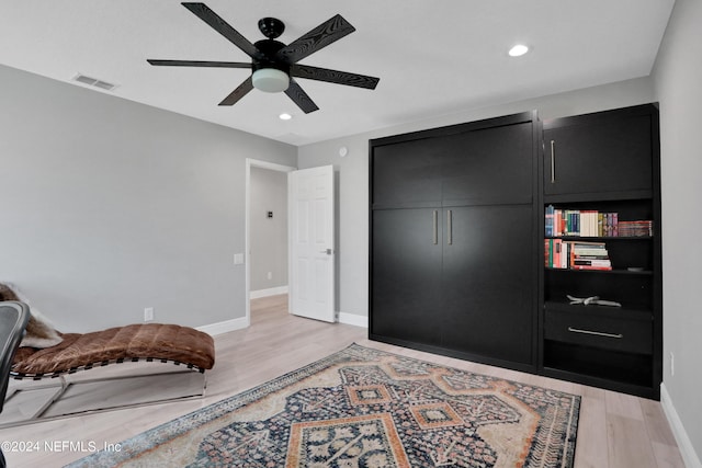 bedroom featuring baseboards, a closet, visible vents, and light wood-style floors