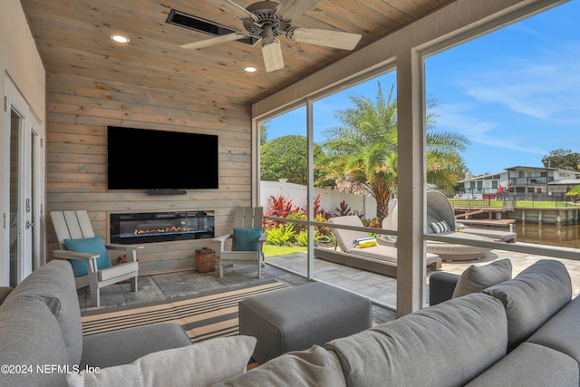 interior space with wooden walls, recessed lighting, wooden ceiling, and a water view