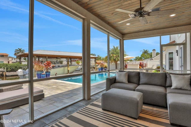 sunroom with wood ceiling and a ceiling fan