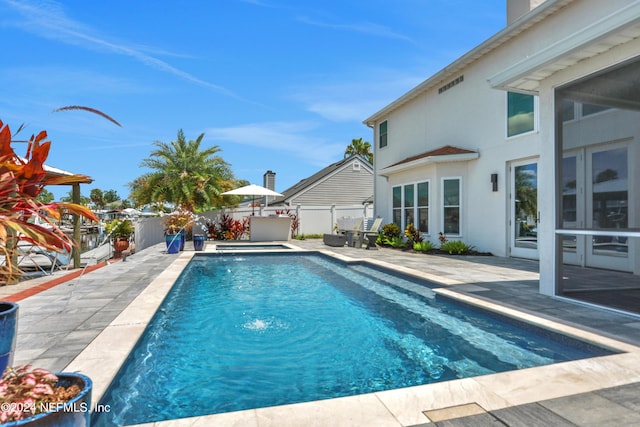 view of swimming pool featuring a patio area, a fenced backyard, and a fenced in pool