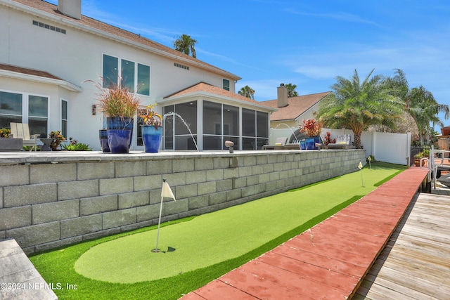 view of yard featuring a fenced backyard and a sunroom