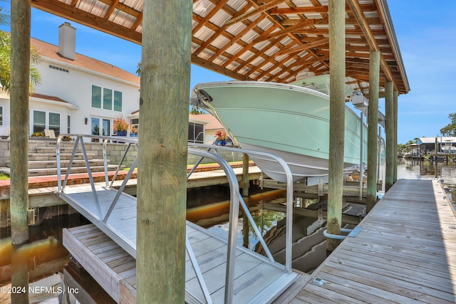 view of dock featuring a water view and boat lift