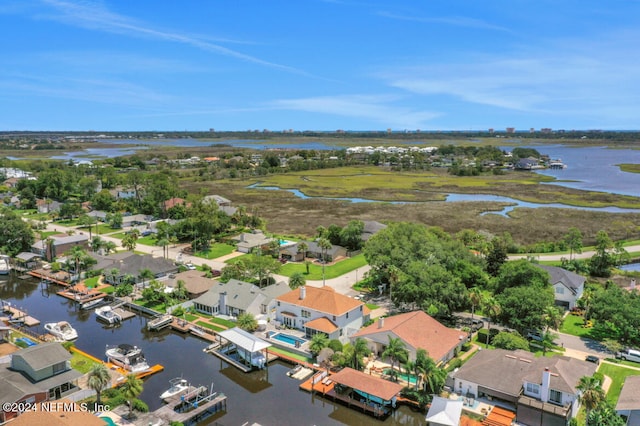 drone / aerial view featuring a residential view and a water view