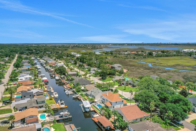 birds eye view of property with a water view and a residential view