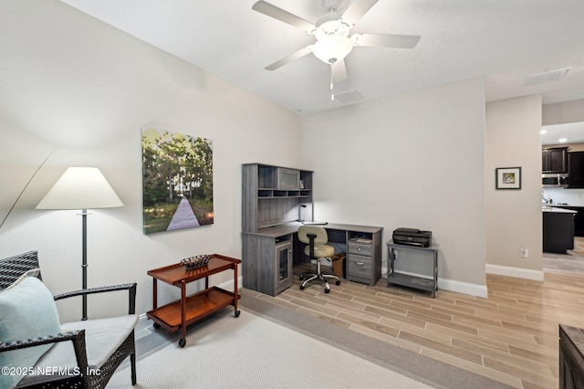 office area with baseboards, a ceiling fan, and wood tiled floor