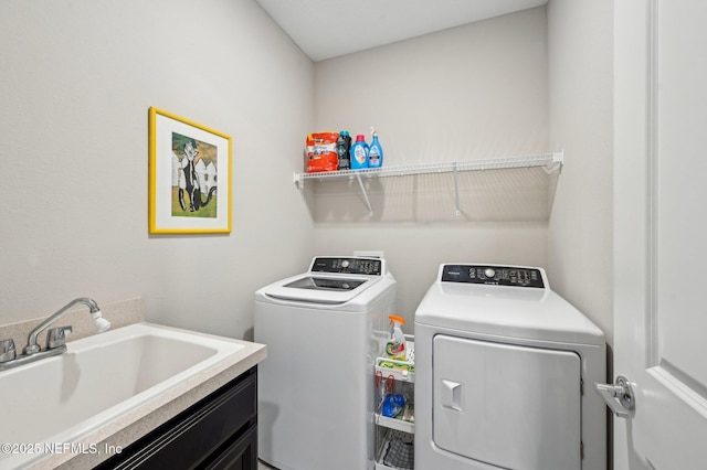 laundry area featuring laundry area, a sink, and washing machine and clothes dryer