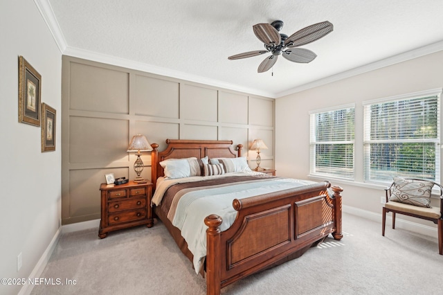 bedroom with a decorative wall, ornamental molding, light carpet, a textured ceiling, and baseboards