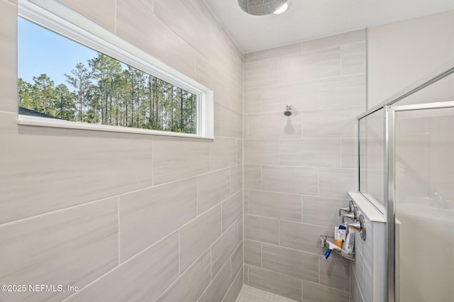 bathroom with tiled shower