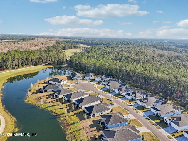 bird's eye view featuring a forest view, a water view, and a residential view