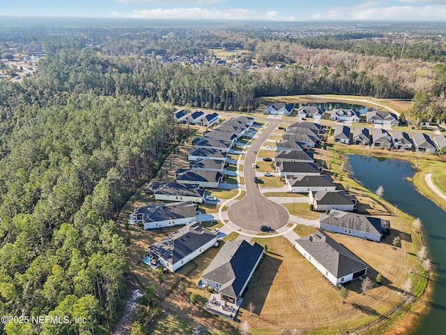 bird's eye view featuring a water view, a wooded view, and a residential view