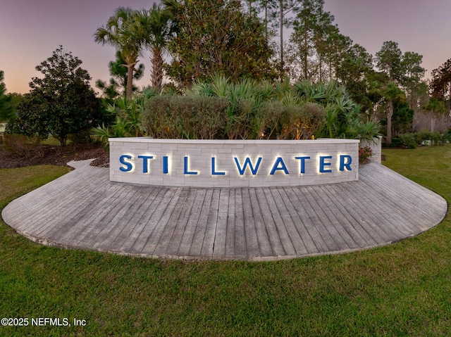 community / neighborhood sign with a lawn