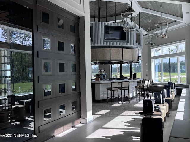 interior space featuring a high ceiling, wood ceiling, and a chandelier
